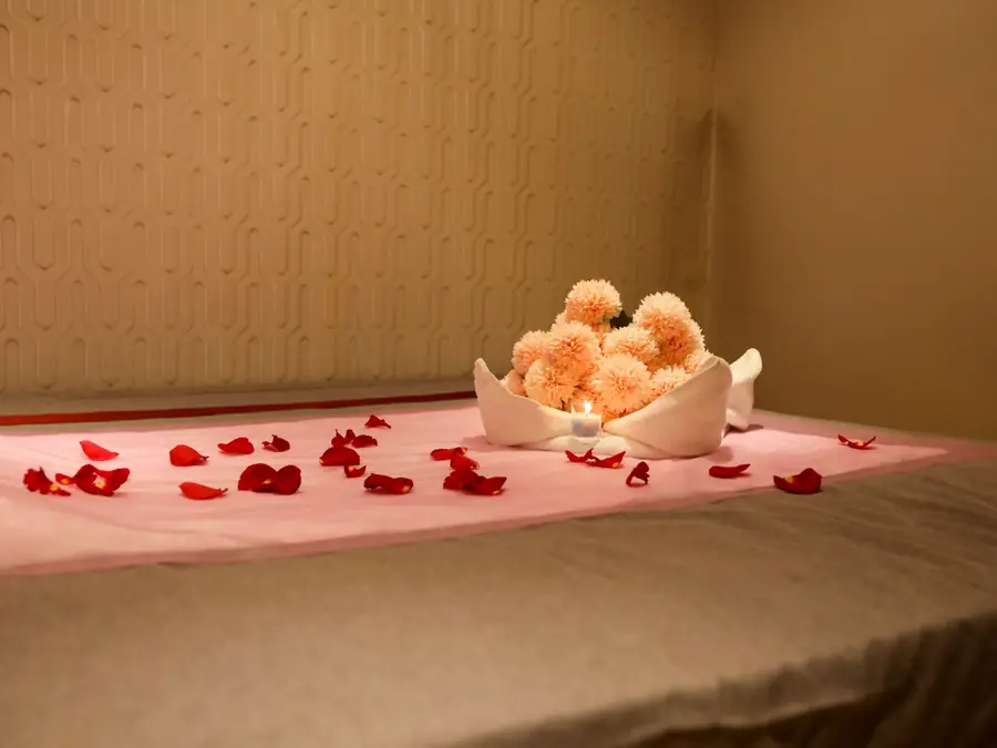 Massage bed dressed with fresh flowers at Impressive Spa, Dubai Marina